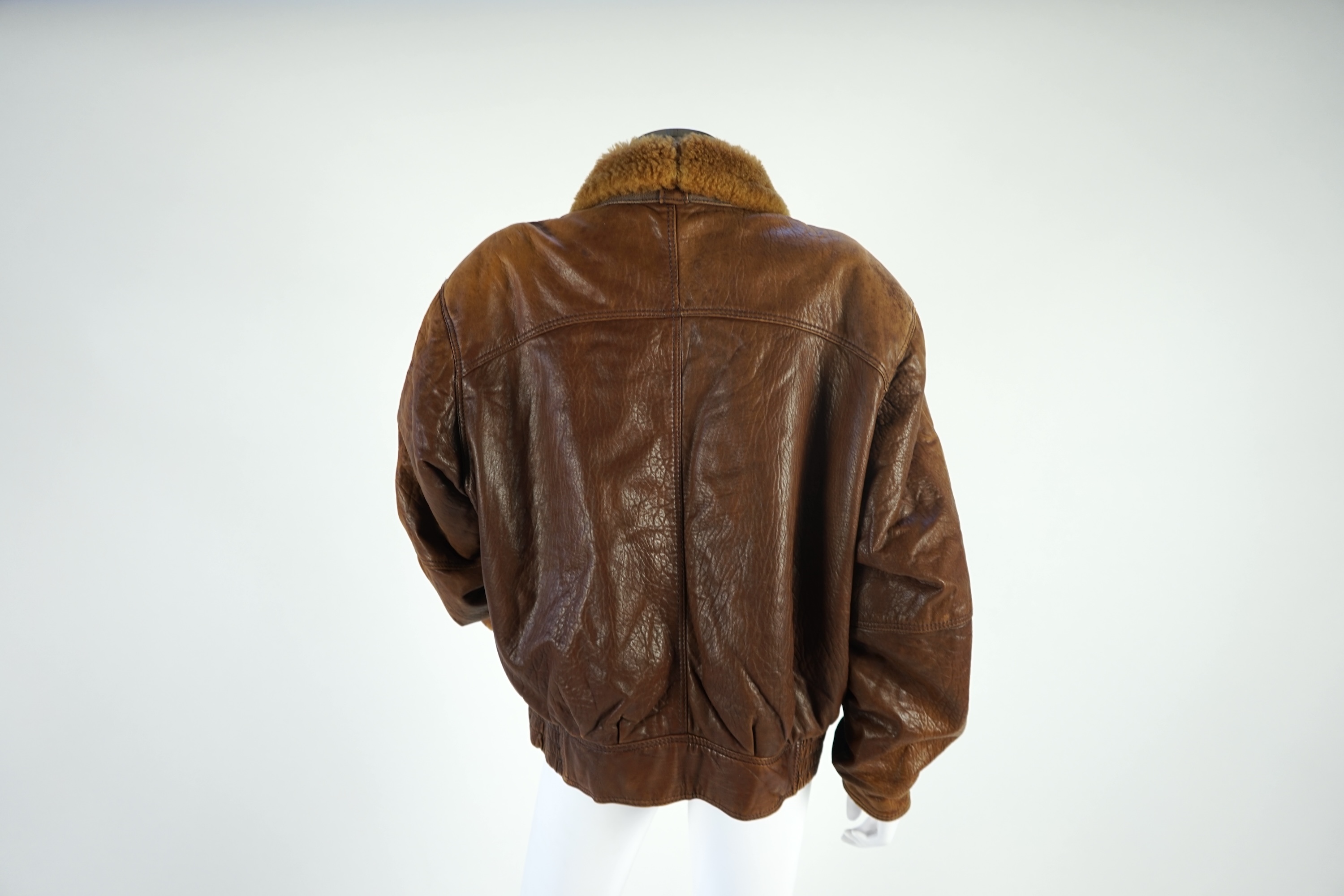 A gentleman's vintage brown leather bomber jacket made by The King, size unknown.